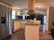 Open kitchen layout with an island, updated appliances and mosaic backsplash at 143 Ezra Rd, Kings Mountain, NC 28086