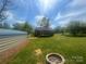 Spacious backyard with room for outdoor entertaining, features a fire pit and detached metal storage shed at 155 Ervin Loop, China Grove, NC 28023