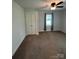 Neutral bedroom with double door closet, carpet, and a window providing natural light at 155 Ervin Loop, China Grove, NC 28023
