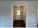 Clean hallway with neutral paint, wood floors, closet and access to the backyard at 155 Ervin Loop, China Grove, NC 28023