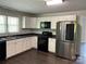 Bright kitchen with white cabinets, stainless steel appliances and a double sink at 155 Ervin Loop, China Grove, NC 28023