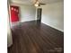 Spacious living room with dark wood flooring and a bright red entry door at 155 Ervin Loop, China Grove, NC 28023