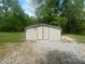 Exterior shot of a metal storage shed on a gravel base, offers great space for tools and equipment at 155 Ervin Loop, China Grove, NC 28023