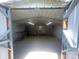 The storage shed interior has gravel flooring, shelving, a workbench, and overhead lighting at 155 Ervin Loop, China Grove, NC 28023
