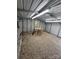 Bright interior of a storage shed, featuring gravel flooring, lighting, and ample room for hobbies and tools at 155 Ervin Loop, China Grove, NC 28023