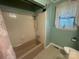 Bathroom showcasing a bathtub and shower, complemented by a window inviting natural light into the space at 1620 Moss Springs Rd, Albemarle, NC 28001