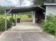 Attached carport with concrete floor and ample parking space, providing covered parking for vehicles at 1620 Moss Springs Rd, Albemarle, NC 28001