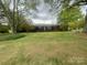 Charming one-story brick home featuring a well-manicured front lawn and mature trees at 1620 Moss Springs Rd, Albemarle, NC 28001