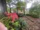 Garden features a wooden swing surrounded by colorful azaleas and a variety of lush plants at 1620 Moss Springs Rd, Albemarle, NC 28001