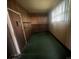 Room features original wood paneling and built-in shelving, lit by natural light from a nearby window at 1620 Moss Springs Rd, Albemarle, NC 28001