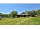 Back view of a brick house with a lawn and covered patio at 1684 Montevista Dr, Shelby, NC 28150