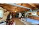 Open basement area featuring wood-paneled ceiling, concrete floors, and ample storage space at 1684 Montevista Dr, Shelby, NC 28150