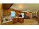 Open kitchen and living area with wood paneled walls and vintage flooring at 1684 Montevista Dr, Shelby, NC 28150