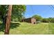 Brick home with a spacious yard, mature trees, and a storage shed at 1684 Montevista Dr, Shelby, NC 28150
