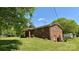 Brick home with a spacious yard, mature trees, and a storage shed at 1684 Montevista Dr, Shelby, NC 28150