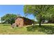 View of a brick house surrounded by trees and green grass at 1684 Montevista Dr, Shelby, NC 28150