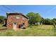 Back view of a brick house with a lawn and shed at 1684 Montevista Dr, Shelby, NC 28150