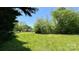 Expansive grassy yard surrounded by mature trees offers plenty of space and privacy at 1684 Montevista Dr, Shelby, NC 28150