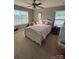 Bright bedroom featuring a large window, ceiling fan, and cozy furnishings at 1905 Yellow Daisy Dr, Matthews, NC 28104
