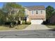 Traditional two-story home with a brick facade and well-manicured front lawn at 1905 Yellow Daisy Dr, Matthews, NC 28104