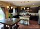 Stylish kitchen with dark cabinets, stainless steel appliances, and an island with seating at 1905 Yellow Daisy Dr, Matthews, NC 28104