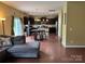 Open-concept living area with hardwood floors, access to the kitchen, and natural light at 1905 Yellow Daisy Dr, Matthews, NC 28104