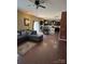 Open-concept living room featuring hardwood floors, a comfortable couch, and eat-in kitchen at 1905 Yellow Daisy Dr, Matthews, NC 28104