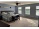 Spacious main bedroom featuring large windows for ample natural light and a cozy seating area at 1905 Yellow Daisy Dr, Matthews, NC 28104