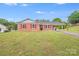 Charming one-story home with red shutters, a well-manicured lawn, and a convenient covered carport at 218 Valleybrook Ln, Troutman, NC 28166