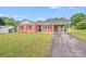 Charming brick home with vibrant red shutters and a carport at 218 Valleybrook Ln, Troutman, NC 28166