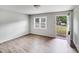 Bright living room featuring new vinyl floors and an open door with views of the front yard at 218 Valleybrook Ln, Troutman, NC 28166
