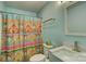 Stylish bathroom with marble vanity, elongated toilet and colorful shower curtain at 221 Delview Dr, Cherryville, NC 28021