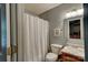 Cozy bathroom with a single sink vanity, standard toilet and shower tub with curtain at 221 Delview Dr, Cherryville, NC 28021