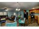 Comfortable living room with wood flooring, ceiling fan, and open layout to the kitchen with wood cabinets at 221 Delview Dr, Cherryville, NC 28021