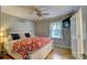 Cozy bedroom featuring hardwood floors, stylish ceiling fan, and a mounted television for ultimate relaxation at 221 Delview Dr, Cherryville, NC 28021