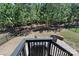 View of a backyard with a patio, grill and wooded area beyond a black iron fence at 2333 Talon Point Cir, Fort Mill, SC 29715