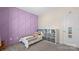 Cozy bedroom featuring stylish purple accent wall and soft gray carpet for a comfortable space at 2333 Talon Point Cir, Fort Mill, SC 29715