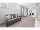 Bright bedroom with a comfortable couch, dresser, large windows, and a neutral color scheme at 2333 Talon Point Cir, Fort Mill, SC 29715