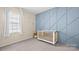 Serene Bedroom with blue accent wall, soft carpet, and a bright, airy window at 2333 Talon Point Cir, Fort Mill, SC 29715