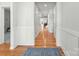 Inviting hallway featuring pristine white walls with elegant wainscoting and beautiful hardwood flooring at 2333 Talon Point Cir, Fort Mill, SC 29715
