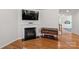 Cozy living room featuring a fireplace, hardwood floors, and a sleek console table at 2333 Talon Point Cir, Fort Mill, SC 29715