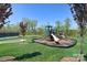 Community playground area with slides, climbers, and surrounding grassy areas, and tennis court at 2333 Talon Point Cir, Fort Mill, SC 29715