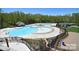 Resort-style pool area with sun deck, splash fountain, and lush surrounding landscaping at 2333 Talon Point Cir, Fort Mill, SC 29715