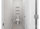 A bright powder room with neutral paint, updated fixture and decorative floating shelves at 2333 Talon Point Cir, Fort Mill, SC 29715