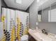 Bathroom features grey walls, a shower/tub with a yellow and grey curtain, and vanity at 268 Jefferson Ne Ct, Concord, NC 28025