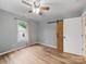 Bedroom features wood-look flooring, a ceiling fan, and a sliding barn door for closet access at 268 Jefferson Ne Ct, Concord, NC 28025