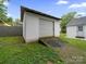 View of the detached one-car garage with gravel in the backyard at 268 Jefferson Ne Ct, Concord, NC 28025