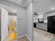 Hallway with access to the kitchen, and a nearby bathroom with yellow shower curtain and floor mat at 268 Jefferson Ne Ct, Concord, NC 28025