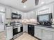 Stylish kitchen with gray cabinets, stainless steel appliances and designer backsplash at 268 Jefferson Ne Ct, Concord, NC 28025