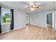 Sunlit living room featuring stylish flooring, a ceiling fan, a bright front door, and neutral paint at 268 Jefferson Ne Ct, Concord, NC 28025